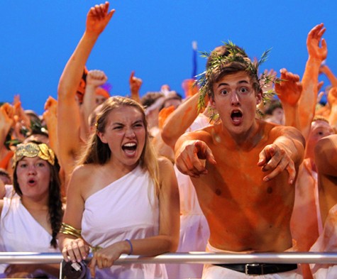 Last year's student section leaders Molly Connor and Sam Lewis cheer on the Olympian football team during the 2014 East vs. North game.
