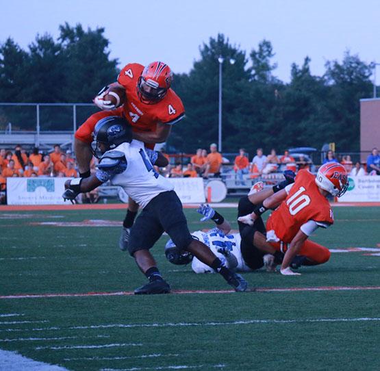 Senior Steven ONeal attempts to leap over a defender during the Olympians game against the Columbus North Bulldogs. 
