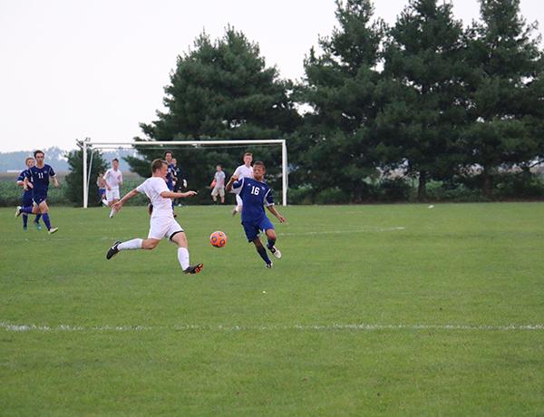 Sophomore Scott Hammond prepares to clear the ball during the first half of the North/East match.