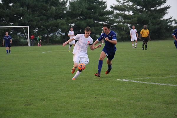 Senior Sam Newell dribbles past a North defender down the sideline during this seasons earlier North/East match. 