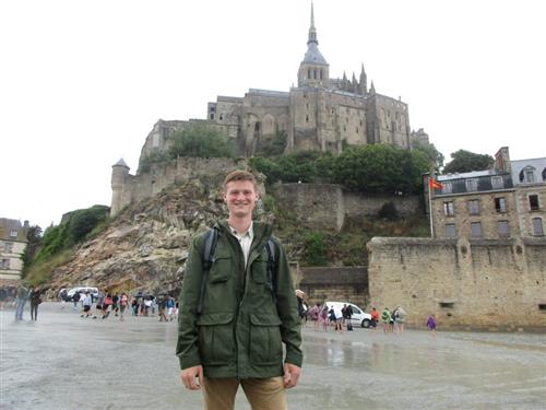 Senior Jacob Harpring stands in front of the Mont Saint-Michel during his trip to France this past summer.