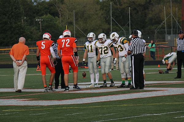 Junior T.C. ONeal (5) and Senior Aaron Kruchten (72) meet the opposing team and referees before the Floyd Central game.