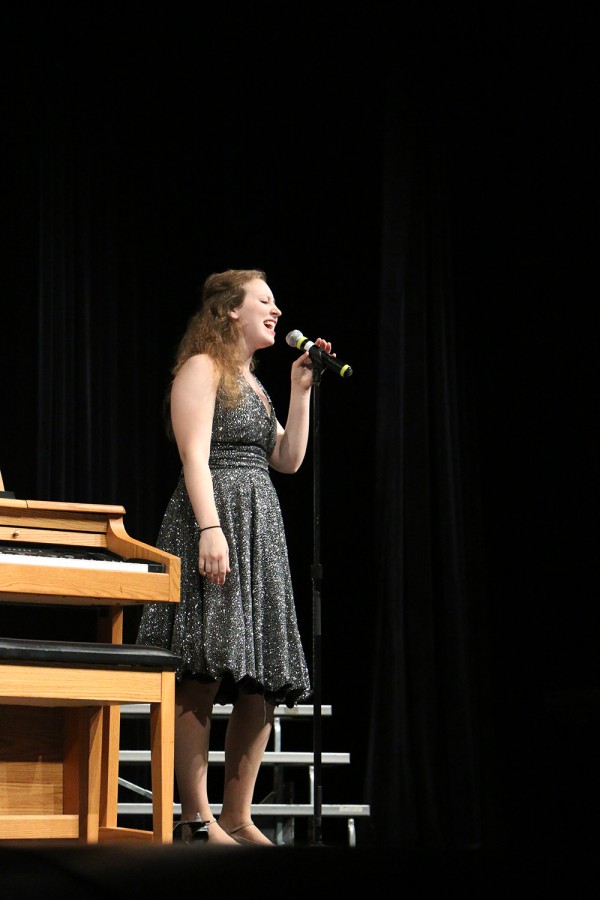 Senior Sarah Harpring sings a solo during Monday nights performance. 