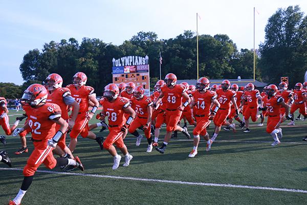 The Olympian football team takes the field during the North/East game on August 28. 