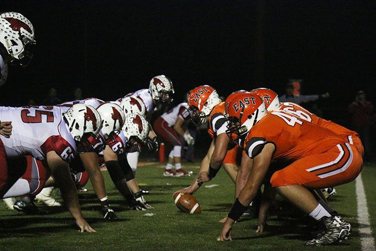 The Olympian offense lines up against the Dragon defense Friday in the sectional championship. 