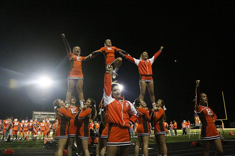 The Olympian Cheerleaders support their team during the game. 