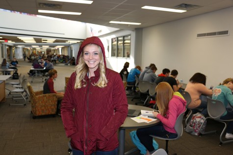 Senior Audrey Wetzel tries on a red G.H. Bass jacket.