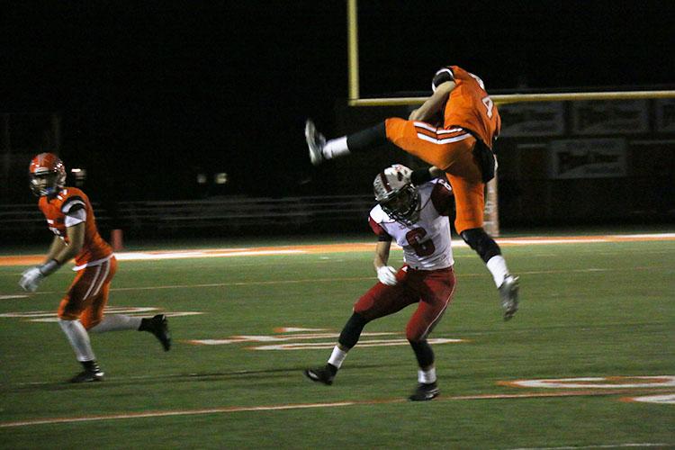 Running back senior Steven ONeal attempts to jump over a Dragon defender. 