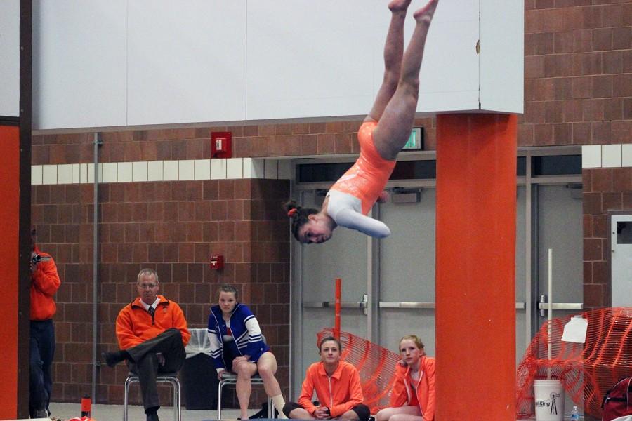 Adi Minor is air bound while completing a full during her floor routine.
