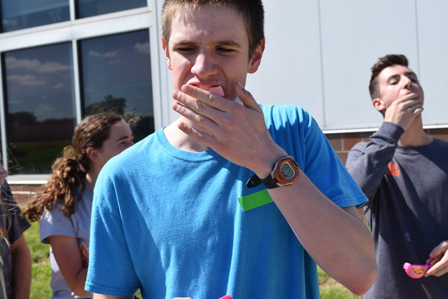 Junior Jonathon Clayton attempts to blow a bubble during the Summer Bash.
