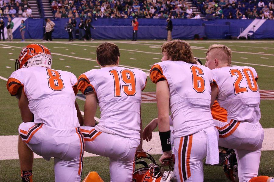 East players take a knee during the fourth quarter.
