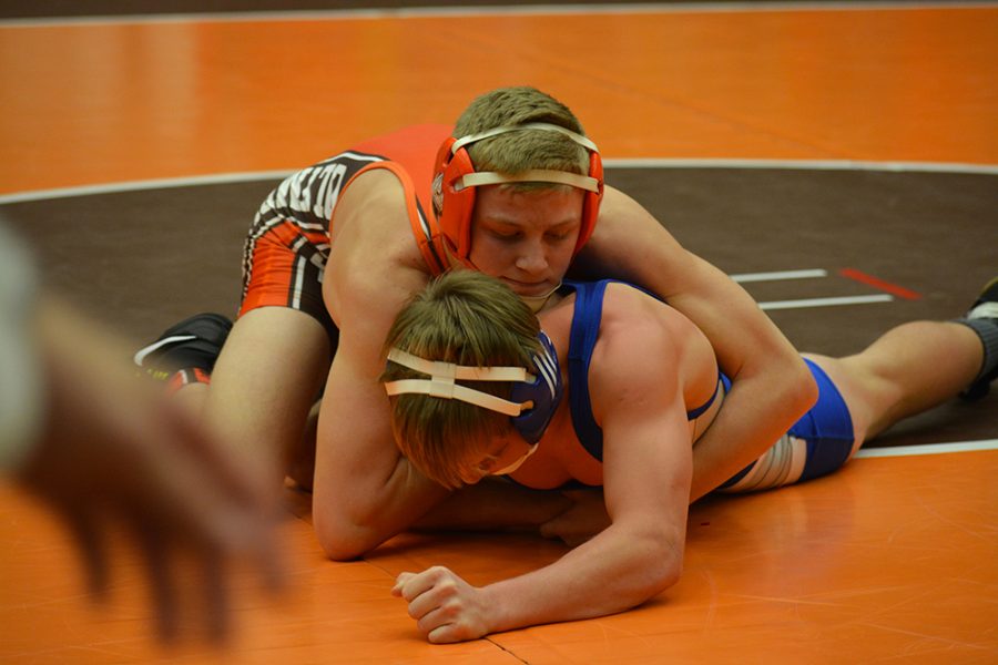 Sophomore Cayden Rooks wrestles his opponent.