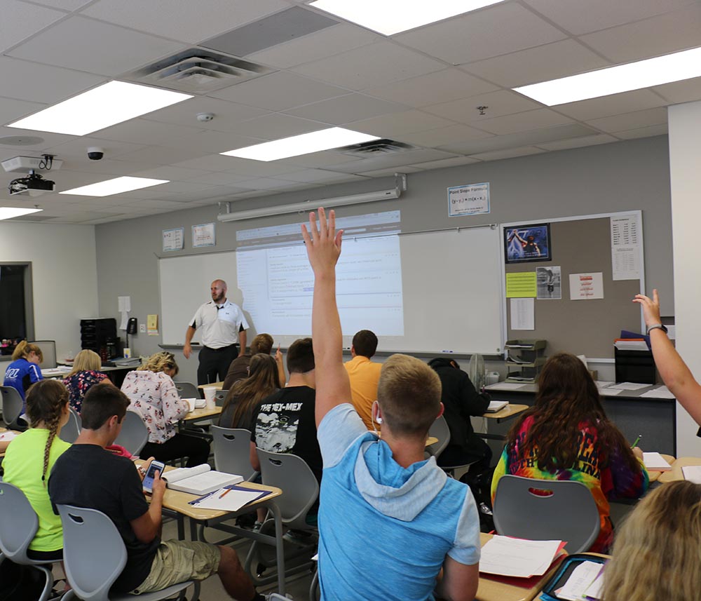 Students listen to Math teacher Chris Cooper.