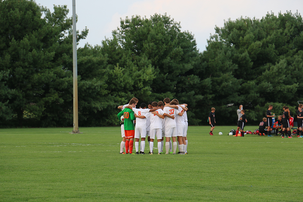 The team gathers in a huddle before the kick off. 