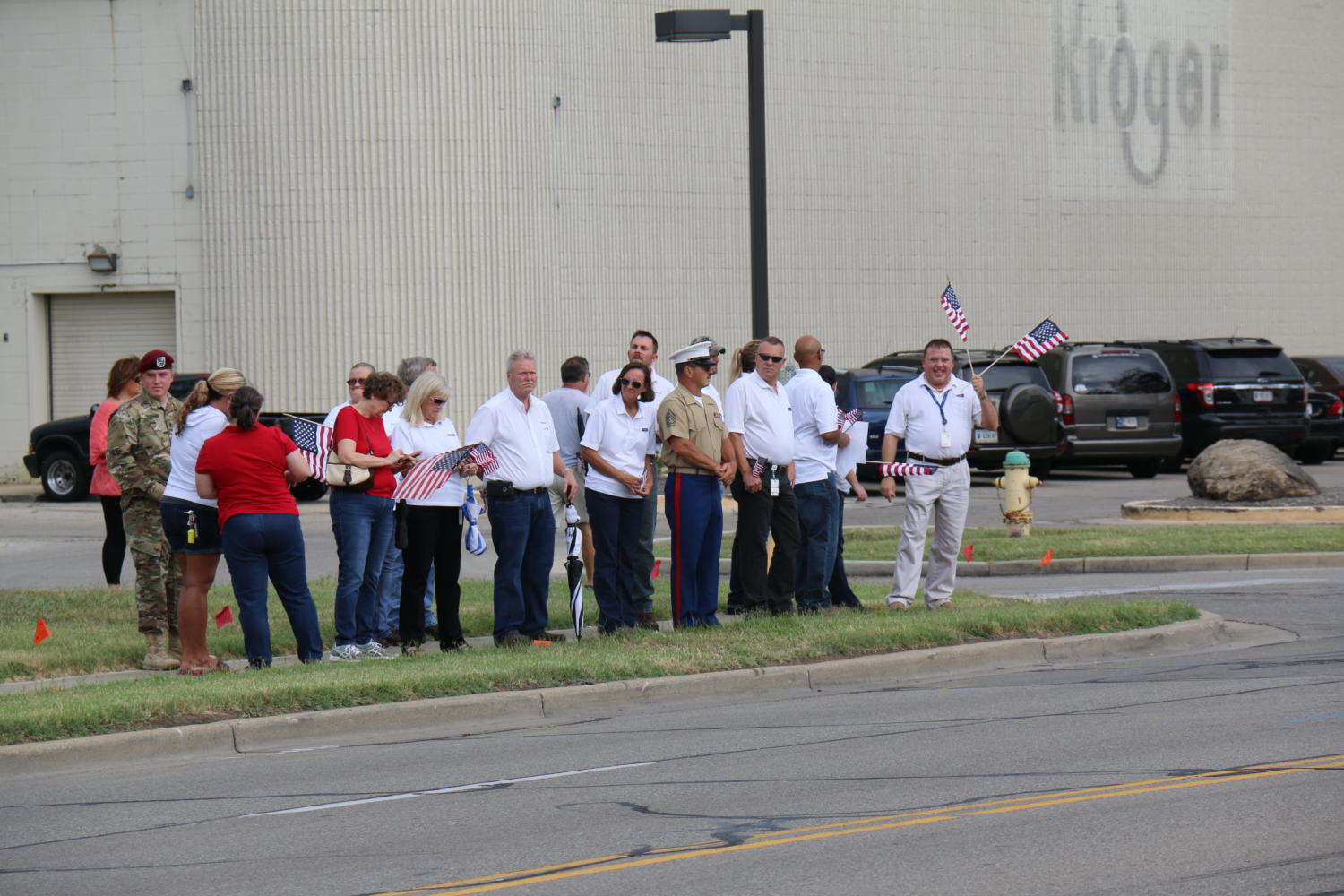 Kroger employees join veterans along the curbside to watch Sgt. Hunters funeral procession.