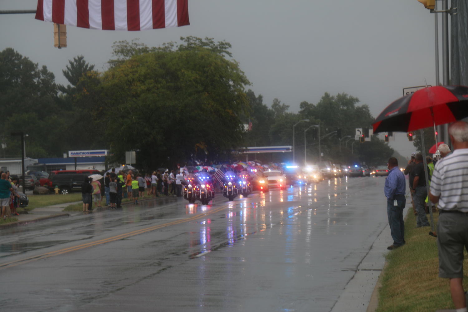 A break in the rain reveals the approach of Sgt. Hunters funeral procession.