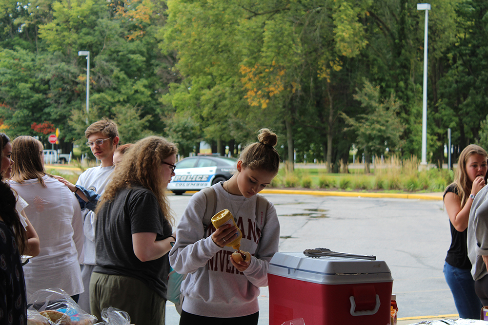Students go through the cookout lunch at the bus lot. 