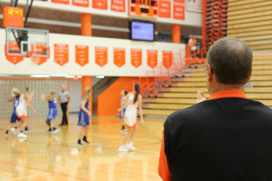 Coach Brown observes the game from the sideline.