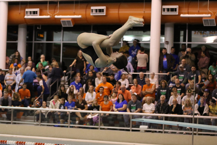 Senior Maggie Gregory performs a dive. 