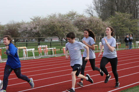Freshman Vanessa Brookes and Matilda Carr run with sophomore Collin Cornett.