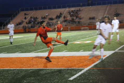Sophomore Logan Cline crosses the ball into the box.
