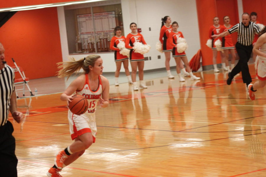 Junior Claire Cunningham dribbles down the court.