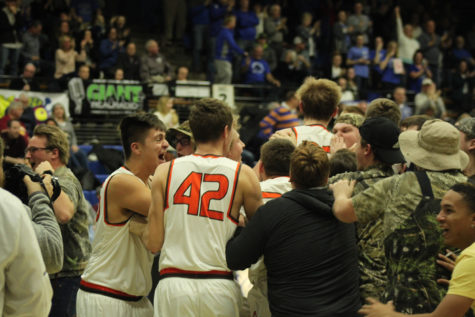 Student section rushing the floor after a buzzer beater.