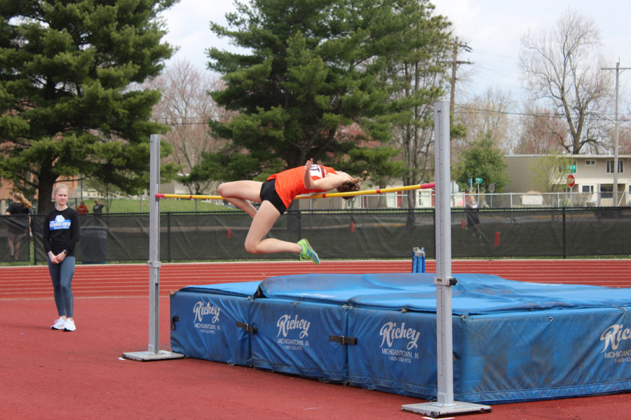 Junior Elena Stoughton makes her first attempt over the bar.