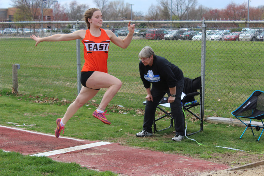 Sophomore Elise LaSell leaps into the air during long jump.