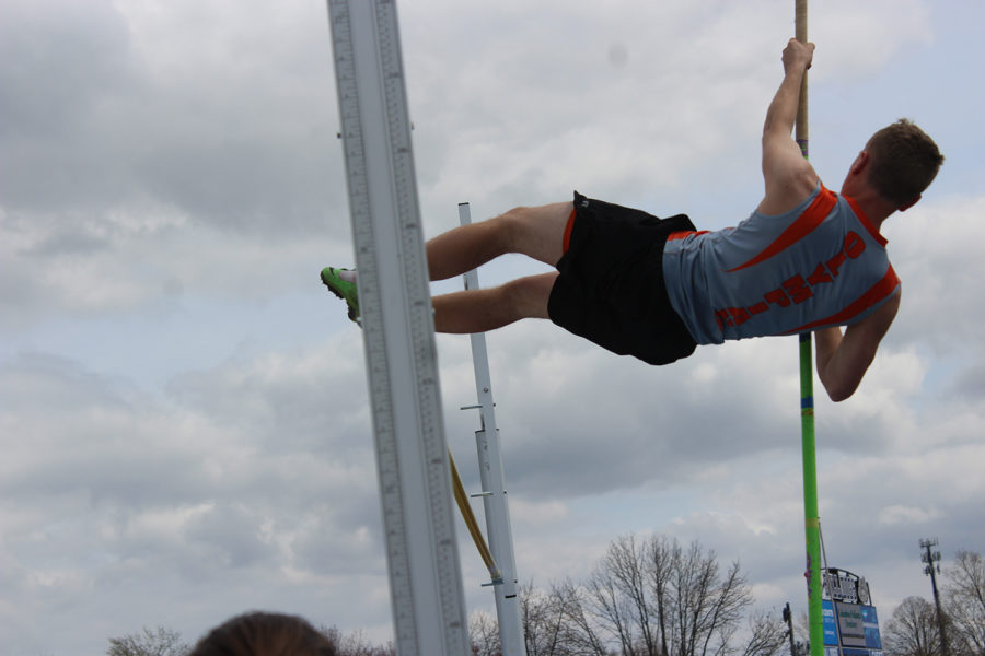 Senior Jared Baker soars over the pole vault bar.