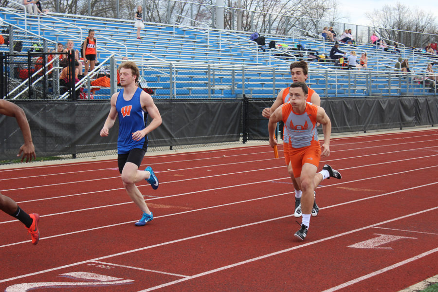 Junior Lance Greiwe takes off to receive the baton in the 400 meter relay.