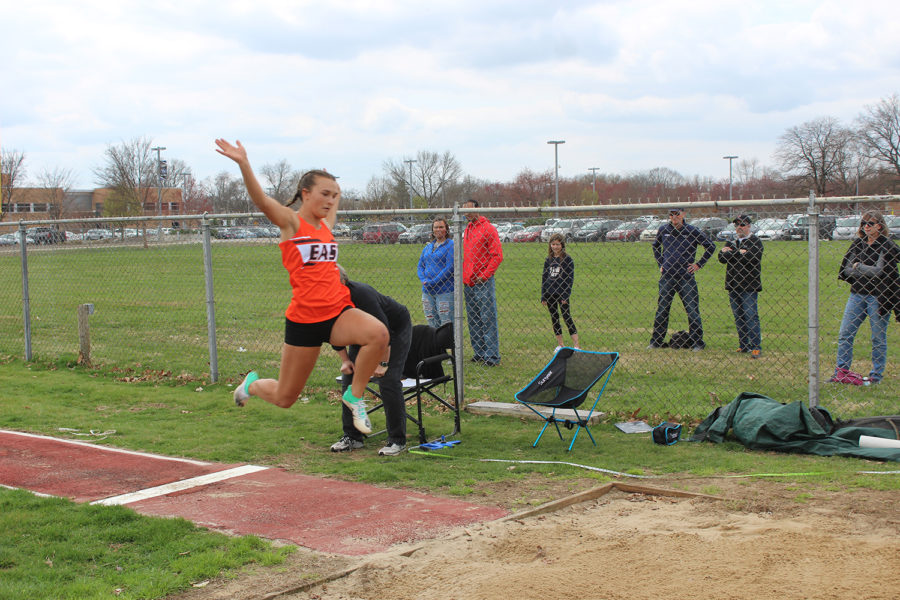Freshman Gabi Schuetz makes her jump into the long jump pit.