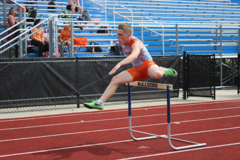 Senior Jared Baker races through the 300 hurdles.