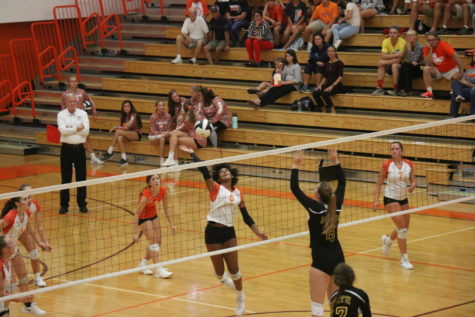Freshman Quarin Bailey goes up to hit the ball in hopes to score against Bloomington North.