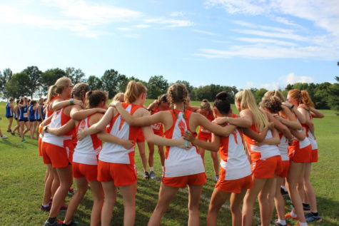 The Olympians huddle around each other and get prepped for the race.