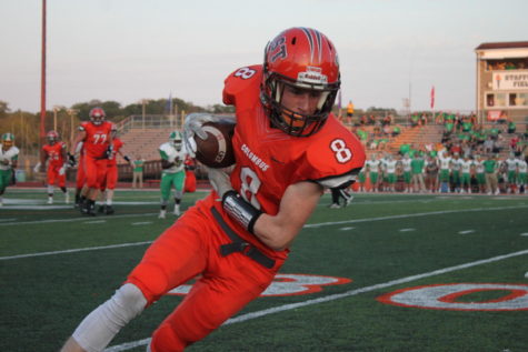 Senior Zander Gentry runs with the ball after it is punted.