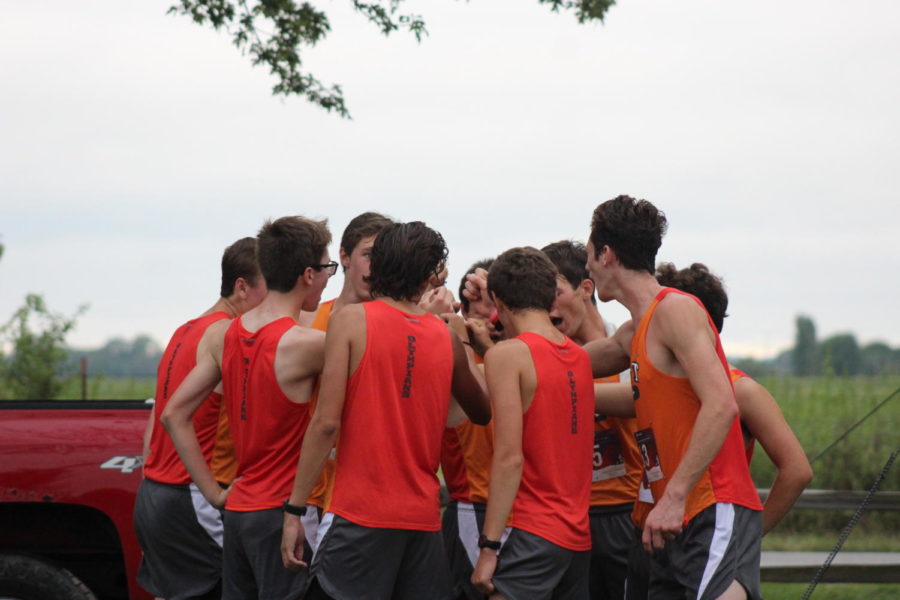 The Olympians huddle up before the race.