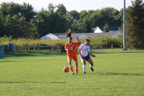 Freshman Cami Warren dribbles around defender.