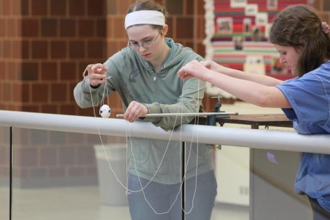 Concentrating on finding the precise location, junior Gloria Henrichsen prepares to drop her egg.