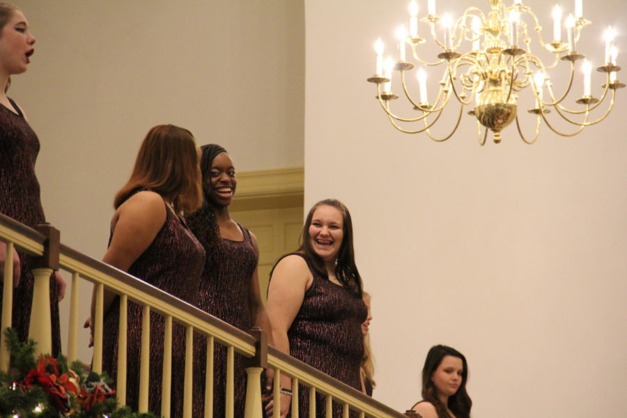 Sophomores Jianna Douglas and Isabelle Sully share a laugh as the audience applauds the performance.