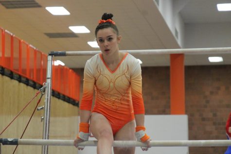 Freshman Sarah Shreve sits in her set position on the bars.