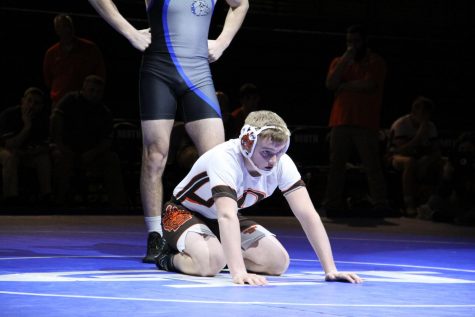 Sophomore Jaden Durnil kneels down in a referee's position.