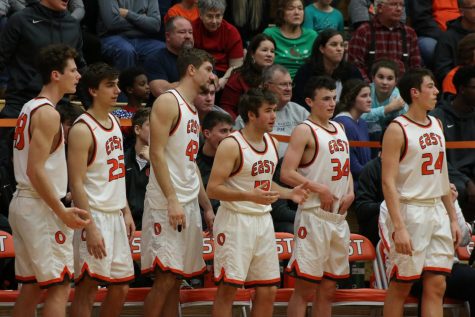 Junior Casey Bartholomew, Junior Elliot Koopman, Senior Seth Chandler, Senior Ben Khulman, Sophomore Will Rieckers and Junior Daniel Murphy cheer on their teammates from the bench.