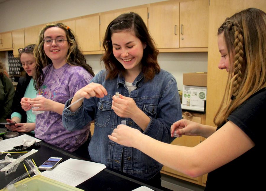 Juniors Amelia Jones, Madeline Romanski and Maggie OConnor break apart strands of DNA in a Genetics lab.