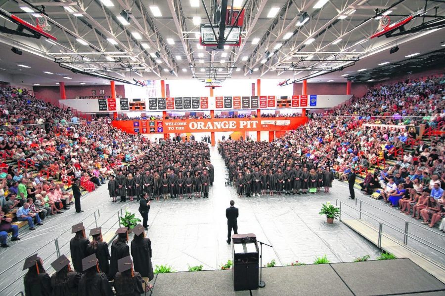 The graduating class of 2019 stands during the Columbus East High School graduation ceremony, Saturday, June 1, 2019. Carla Clark | For The Republic