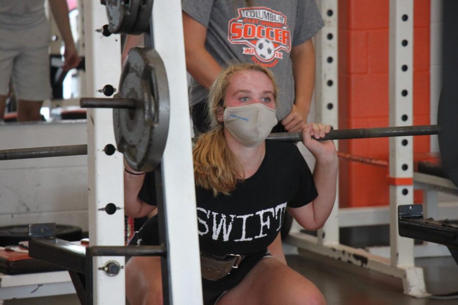 Junior Peyton Meier warms up squat in weight class.