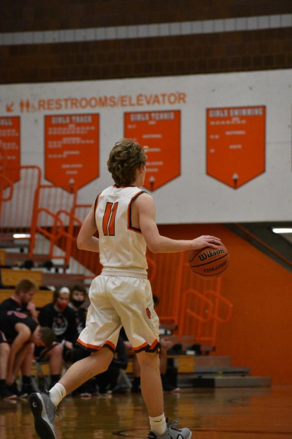 Senior Ben Major dribbles down the court.