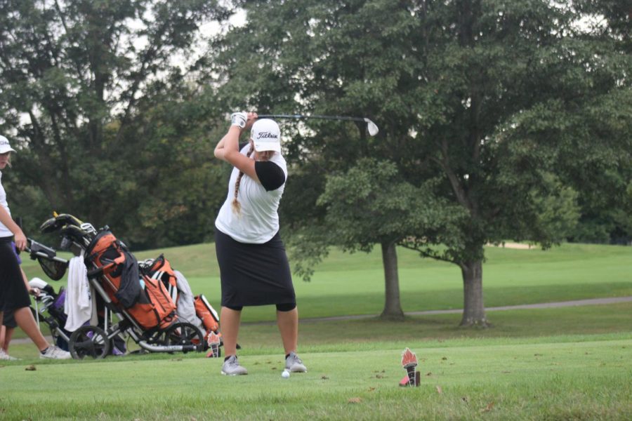 Sophomore Carter Gant takes a swing on hole eight.