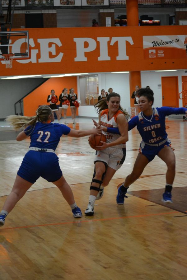 Senior Koryn Greiwe gets blocked while dribbling across the court.