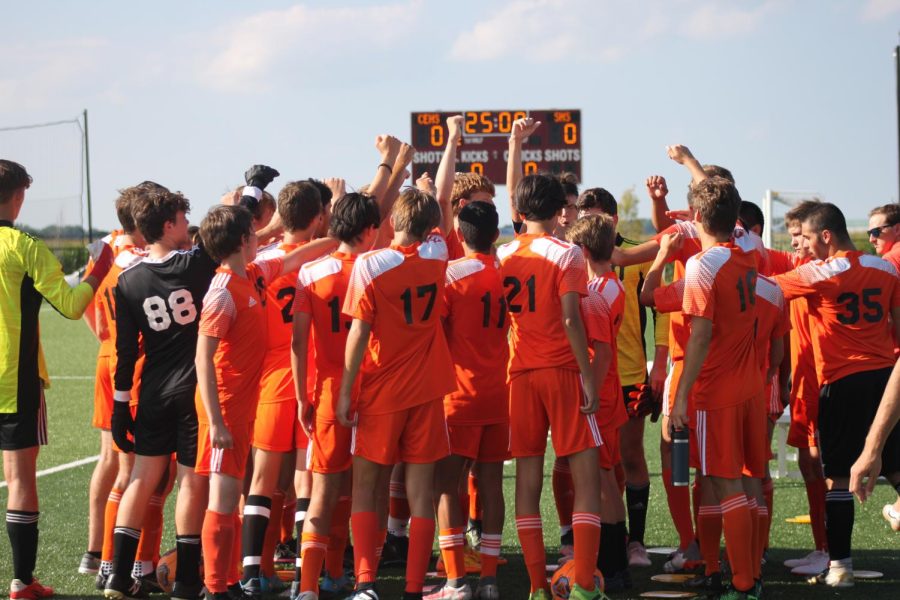 East boy’s soccer engages in a team huddle.